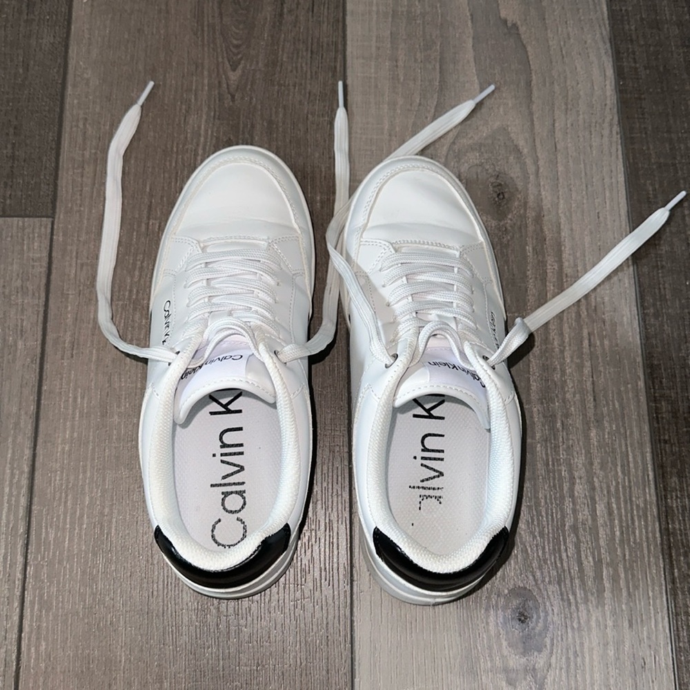 White clean look Calvin Klein sneakers.